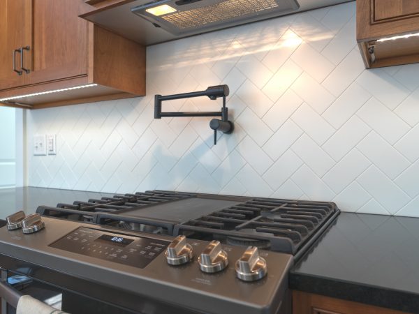 white tile black splash and black quartz countertop