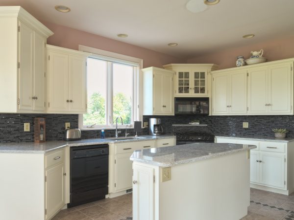 small white Wolf cabinets with marble kitchen island