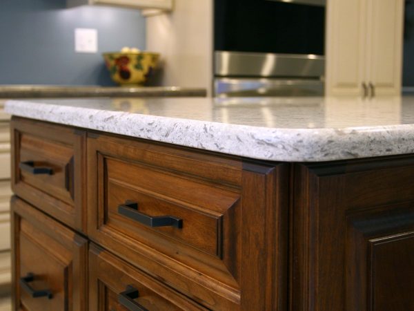 corian kitchen island with wooden drawers