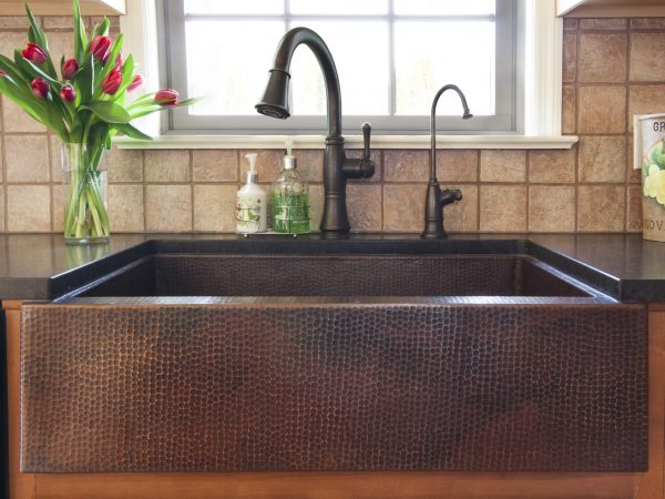 built in sink with black quartz countertops