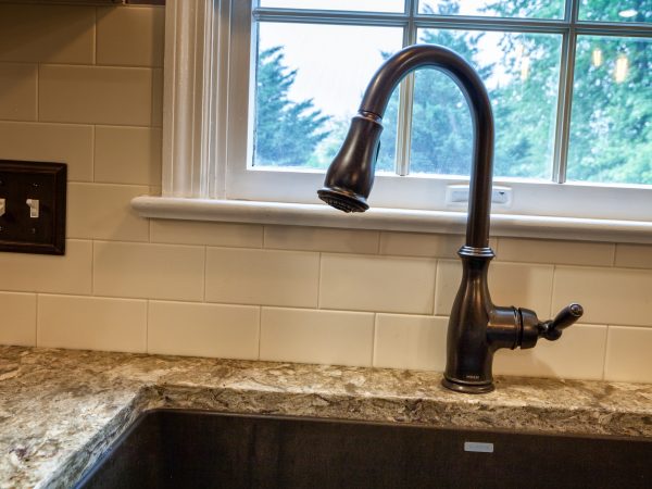 corian countertop with white tile backsplash