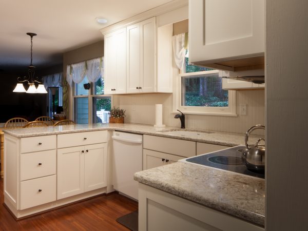 white schrock cabinets with gray granite countertops