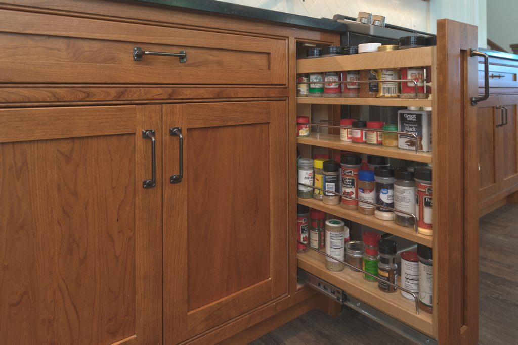 hidden spice rack in wooden cabinets