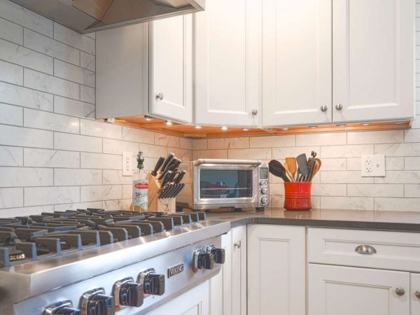 white kitchen cabinets with lights underneath