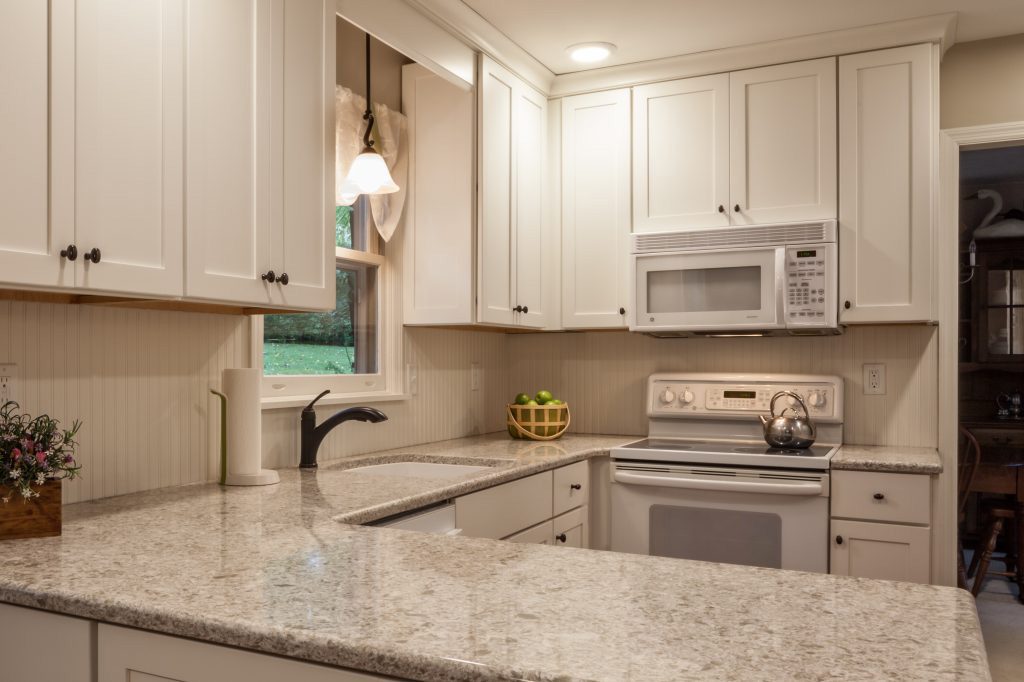 quartz countertops and white kitchen cabinets