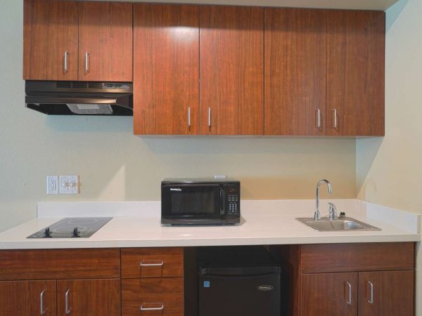 faux wood small kitchen cabinets and white countertop