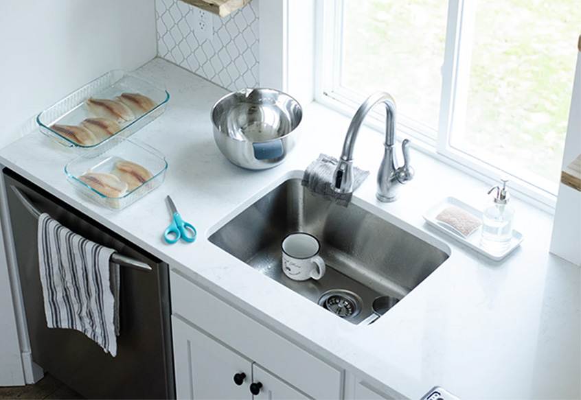 Small transitional kitchen sink in white countertop