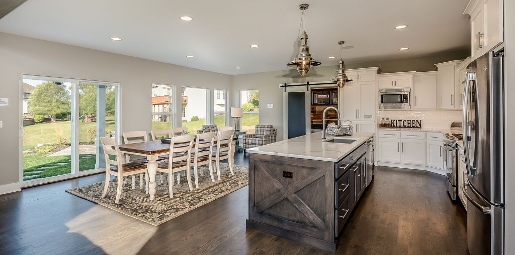 Modern farmhouse kitchen remodel with white cabinets and natural wood island