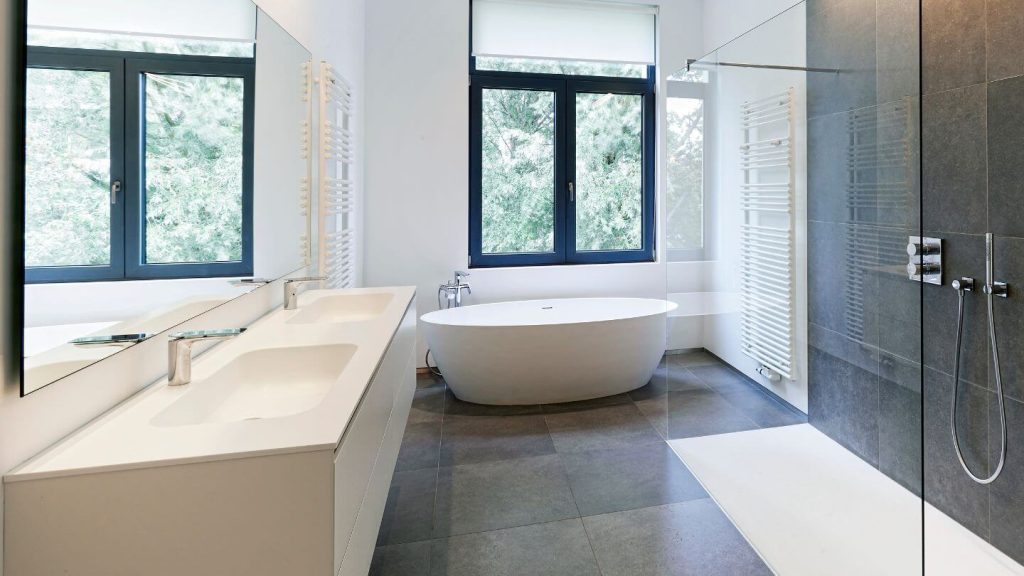 white corian bathroom vanity tops in a dark tiled bathroom