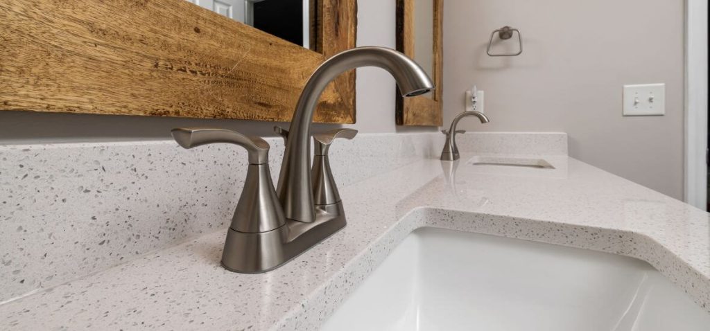 white speckled corian vanity top with sink in the bathroom