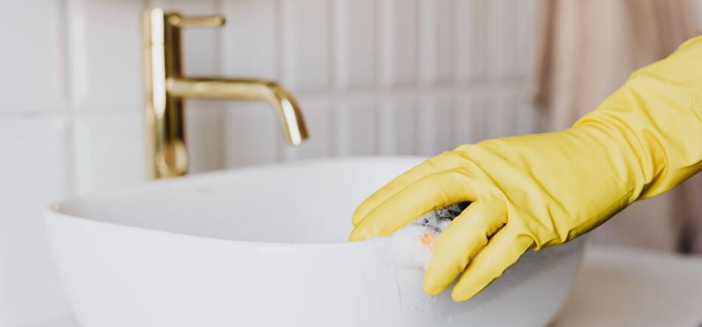 yellow glove cleaning corian sink vanity