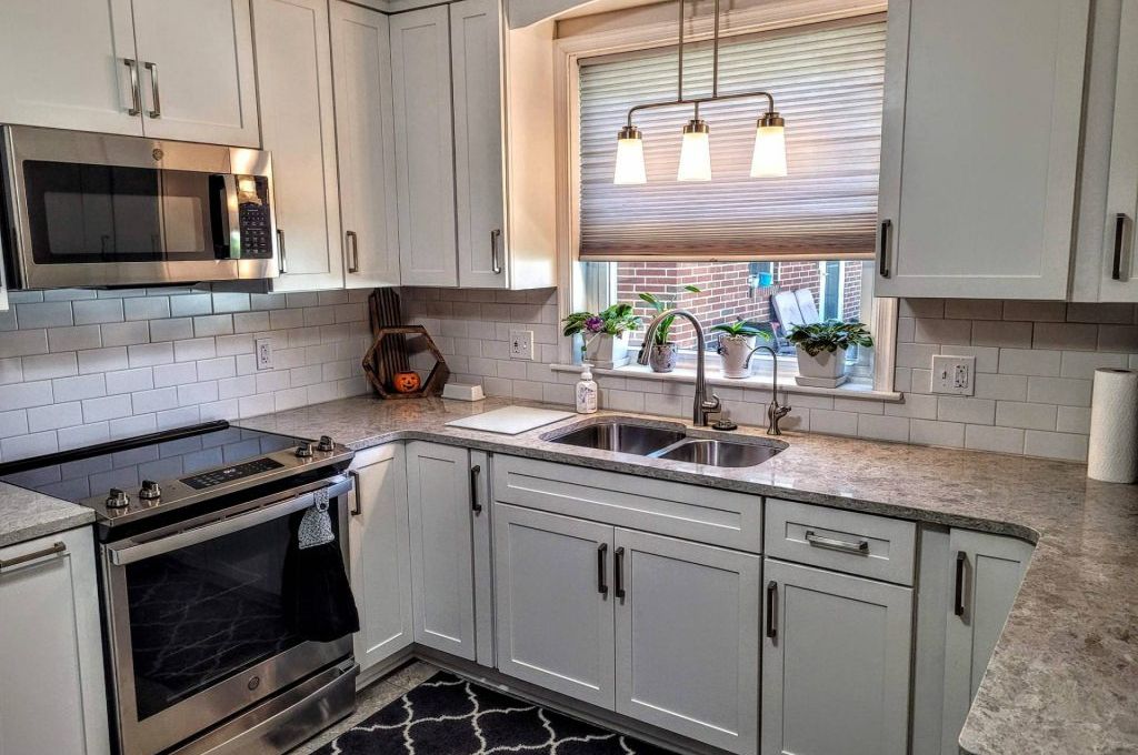 gray matching kitchen cabinets apartment building that feature matte black hardware